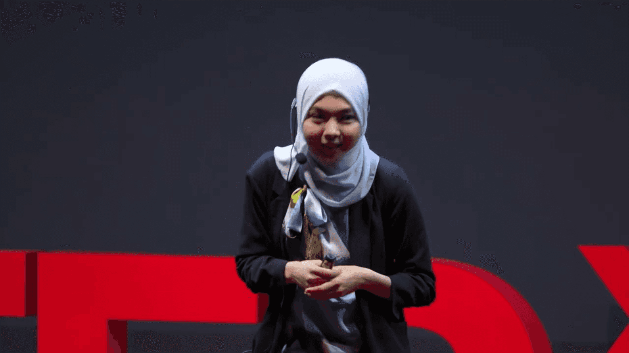 Woman giving a TEDx talk